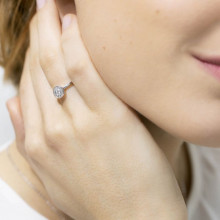 Mano de mujer con anillo modelo rosetón oro blanco y circonitas